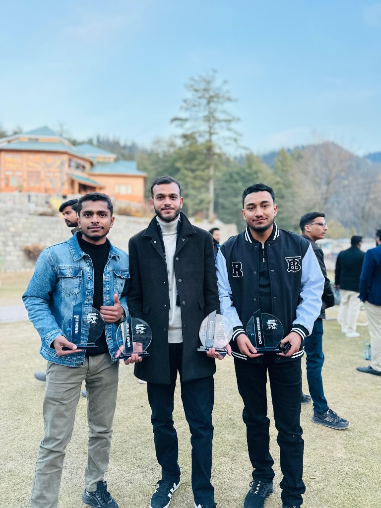 Muhammad Mohiz and colleagues showcasing multiple Rankviz award trophies